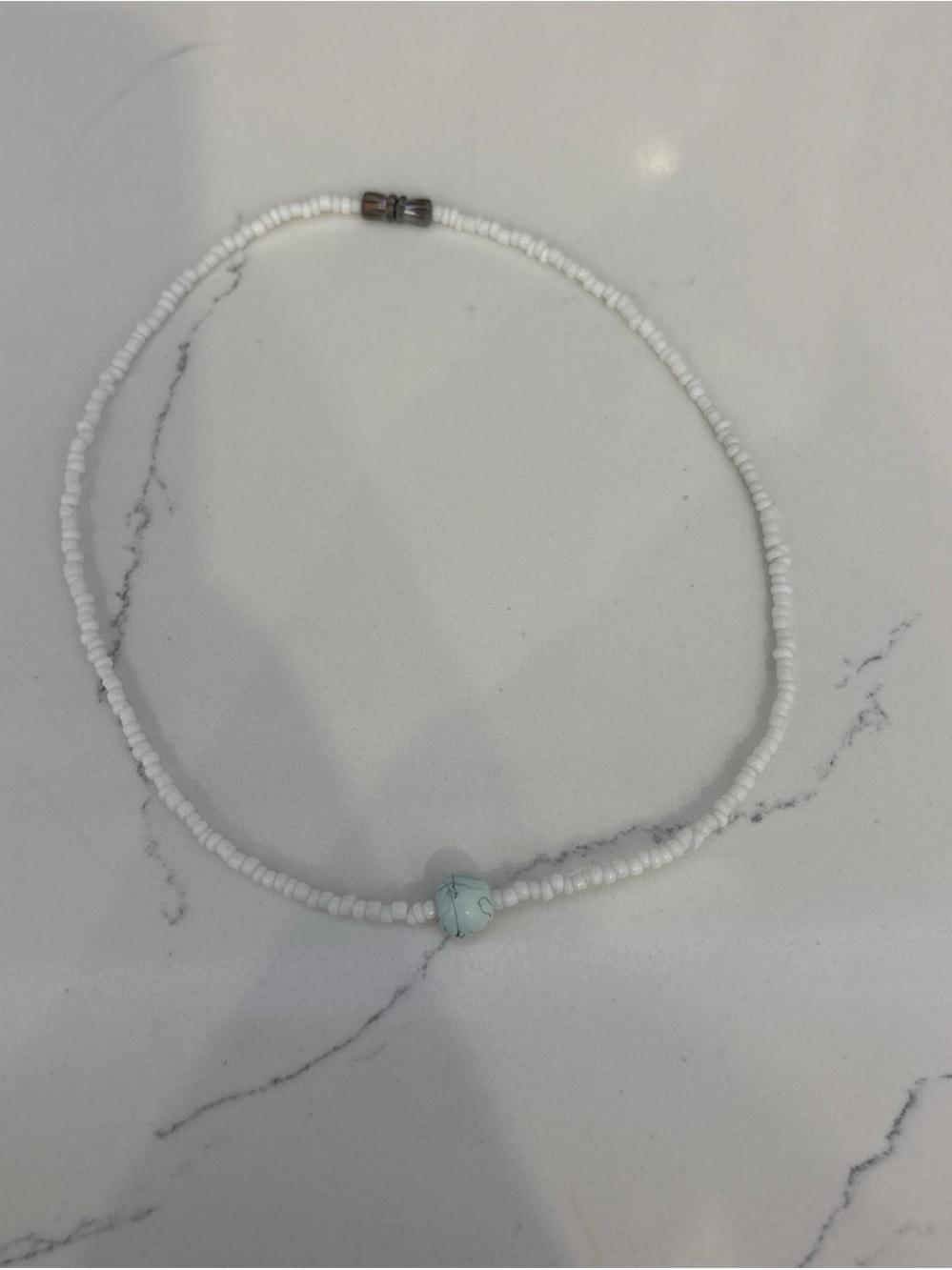 White Beaded Necklace with Light Blue Accent Bead